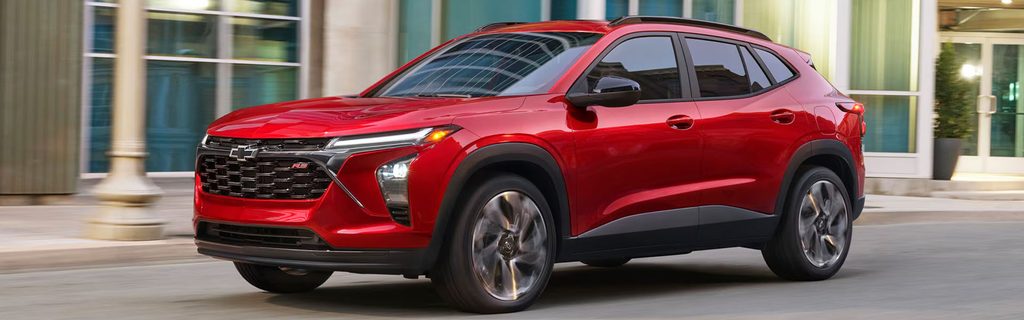 Red Chevrolet Trax RS driving on a city street